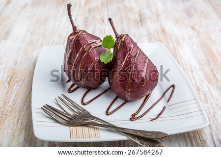 Pears cooked in red wine covered with chocolate