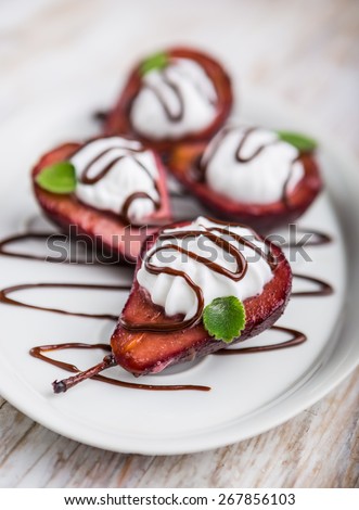 Pears cooked in red wine dipped in whipped cream and chocolate