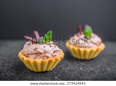 Two small biscuits with chocolate and sweet cream