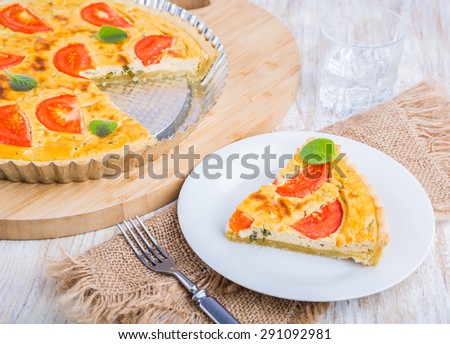 Tart with cottage cheese and tomatoes on wooden table. studio shot