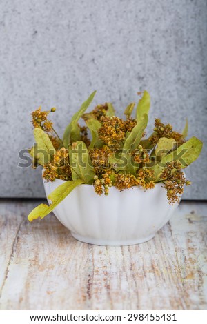 dried flowers of linden on a white wooden table