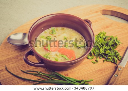 Vintage photo of traditional barley soup with parsley in bowl