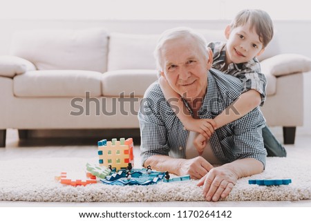 Portrait Grandpa and Grandson Playing with Toys. Family Relationship Between Grandfather and Grandson. Grandpa Teaching, Male Grandchild, Learning Concept. Relations and People Concept.
