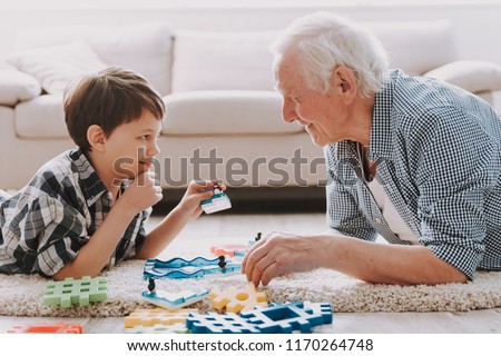 Portrait Grandpa and Grandson Playing with Toys. Family Relationship Between Grandfather and Grandson. Grandpa Teaching, Male Grandchild, Learning Concept. Relations and People Concept.