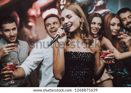 Sing and Drink. Black Dress. Trendy Nightclub. Have Fun. Background. Cheerful. Smiling Girl. Singing Songs. Handsome Men. Beautiful Girls. Friends at Karaoke Club. Karaoke Club. Celebration.