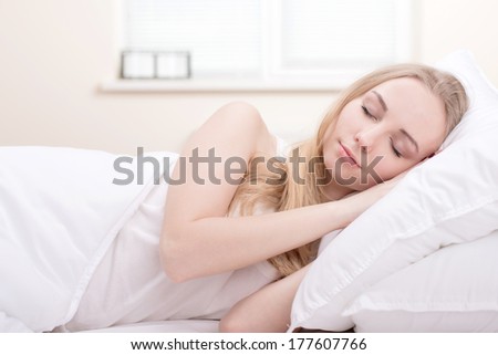 Beautiful girl sleeps in the bedroom