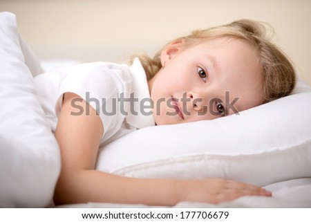 Adorable little girl awaked up in her bed