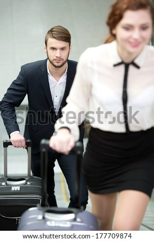 Young business people with a suitcase and plane tickets to travel to the airport trip
