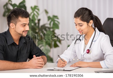 Female Indian physician communication with male patients