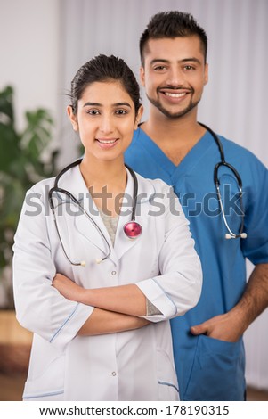 Two Indian doctors sitting working  together