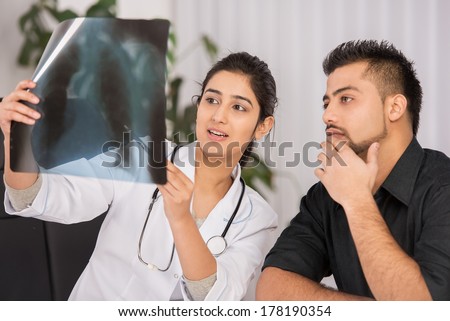 Female Indian physician communication with male patients