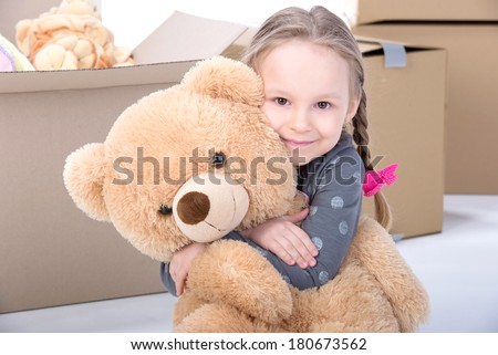 Little girl playing with soft toys. Isolated on white background