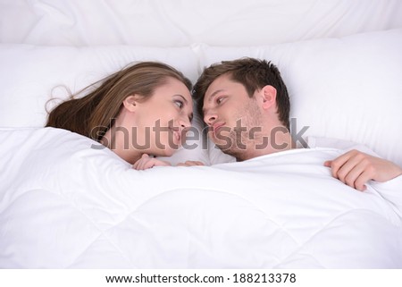Couple in bed. Young loving couple in a bed in a bedroom at home