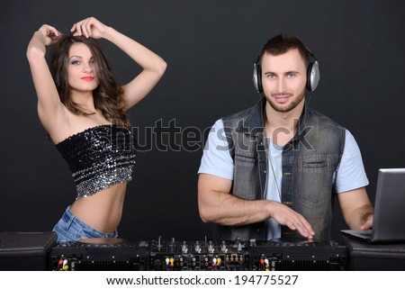 DJ and techno party girl isolated on a dark background