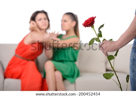 Two angry woman fighting for a man, isolated over white background