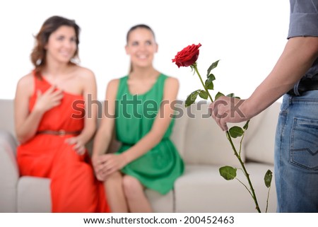 Who to choose? A young man chooses between two girls for the gift of a flower