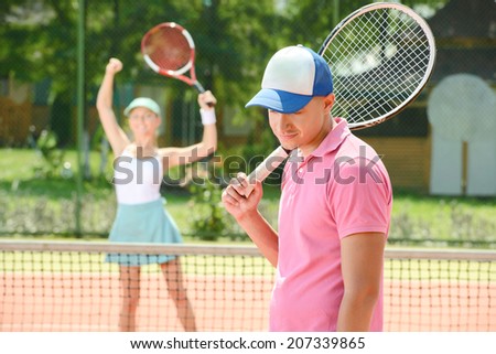 Young male and female tennis players, while playing tennis on the tennis court