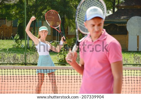 Young male and female tennis players, while playing tennis on the tennis court
