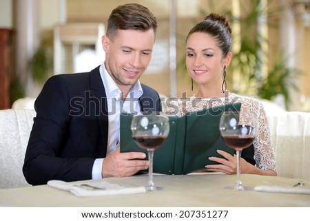 Young elegant couple drinking wine sitting in a restaurant
