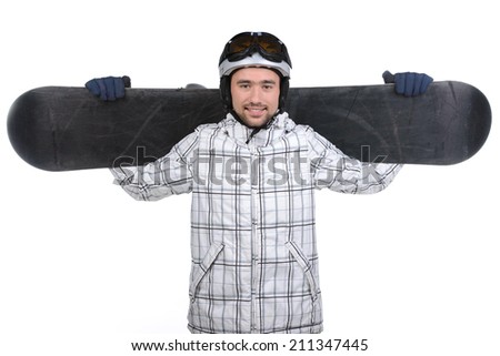 Smiling confident sportsman standing with snowboard. Wearing sport outfit isolated over white background