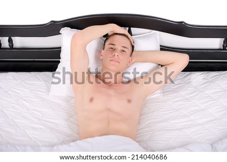 Young, handsome man sleeping in a bed in her bedroom