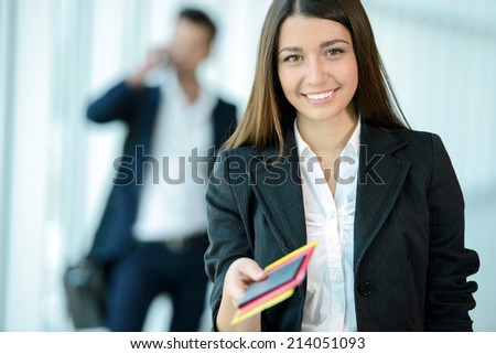 Attractive business woman handing over air ticket at airport check in counter