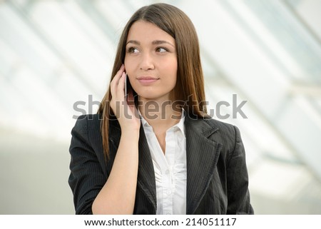 Business woman in business trip with bag and speaking mobile