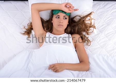 Young beautiful girl is not satisfied, woke up in the morning, not slept. In her bedroom