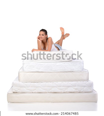 Portrait of a woman lying on many mattresses. Orthopedic mattress.