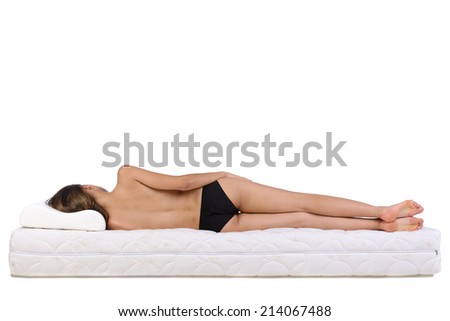 Portrait of a woman lying on a mattress. Orthopedic mattress.