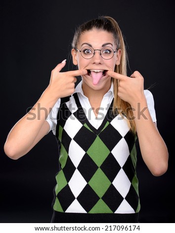 Young nerd woman crazy expression in glasses on black background