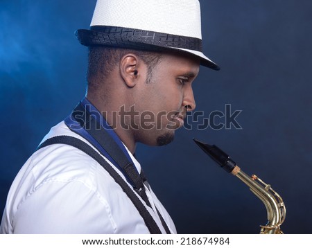 Saxophonist black men in white shirt. Smoke background