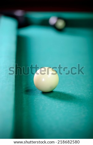 Billiards. Billiard balls on green table and white ball on the foreground