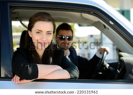 Man and woman in his car stops at petrol station