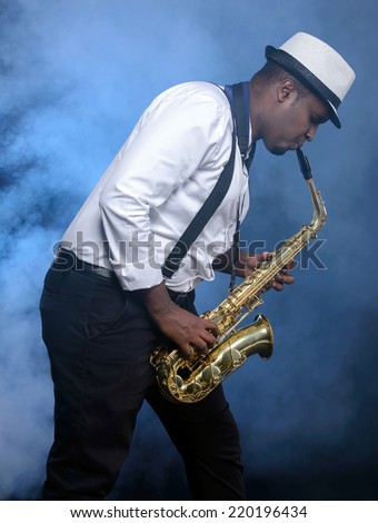 Saxophonist black men in white shirt. Smoke background