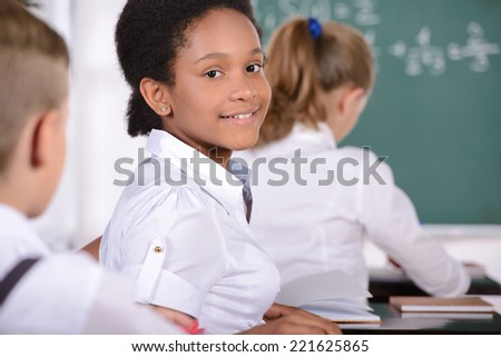 School child with teacher in classroom during lesson. concept of school