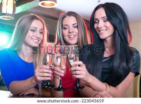 Party, celebration, friends, bachelorette and birthday concept - three beautiful woman in evening dresses with cocktails