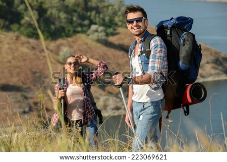 Portrait of couple of happy hikers in the countryside