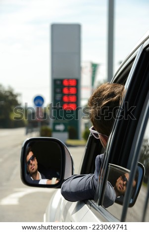 Man in his car stops at petrol station