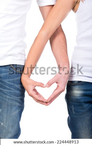 Valentine couple. Portrait of smiling beauty girl and her handsome boyfriend making shape of heart by their hands. Happy joyful family. Love concept. Heart sign. Laughing happy lovers. Valentines Day - stock photo