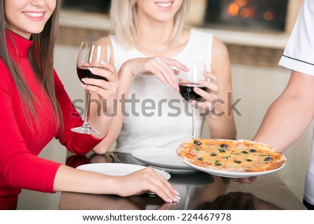 Close-up pizza and wine on the table.