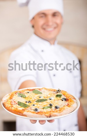 Close-up neapolitan  pizza in chef\'s hand.