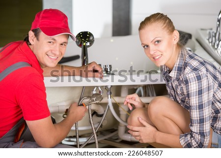 Professional plumber. Plumbing repair service. Woman is showing damage plumbing.