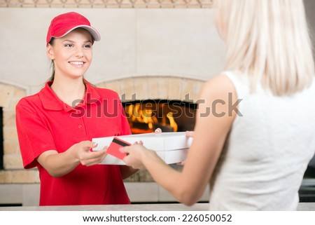 Here is your order.  Hot pizza at your doorstep. Enjoy your meal. Woman delivering pizza.