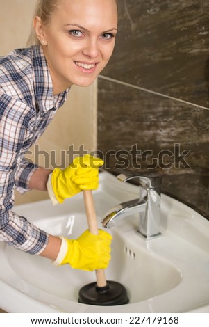 Young woman cleans the sink with air valves.