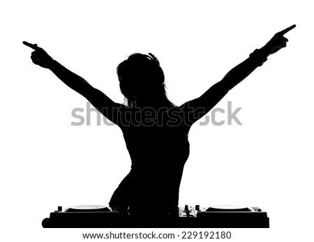 Beautiful busty DJ with her headphones is standing at her deck mixing sound.