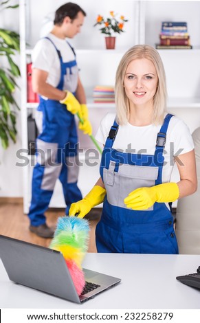 Young couple professional cleaners are cleaning the office.