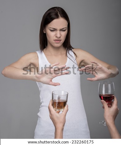 Young woman with alcohol. The concept of bad habits.