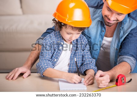 Young father teaches his little son tinkering.