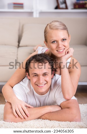 Portrait of a happy young couple at home. Looking at camera and smiling.